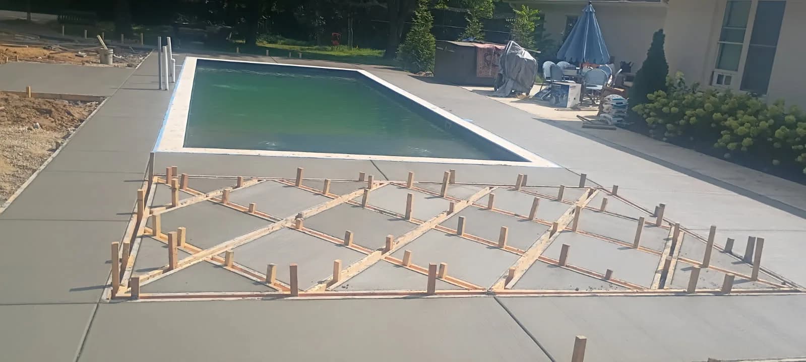 Rectangular pool beside timber formwork prepared for a concrete deck pour